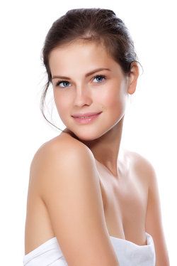 Young, attractive woman holding sheet around breasts